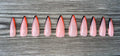 Long Weekend handmade nude press on nails with orange french tips, long stiletto