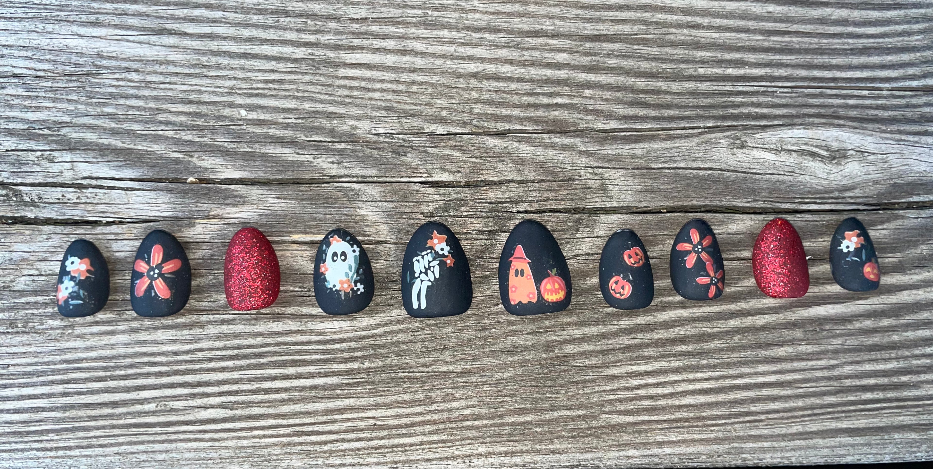Graveyard Garden handmade matte black halloween press on nails with folk florals ghost skeleton hand and pumpkins, short almond