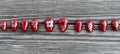 Cursed Heirloom handmade red jelly press on nails with gold filigree charms and jewels, short almond