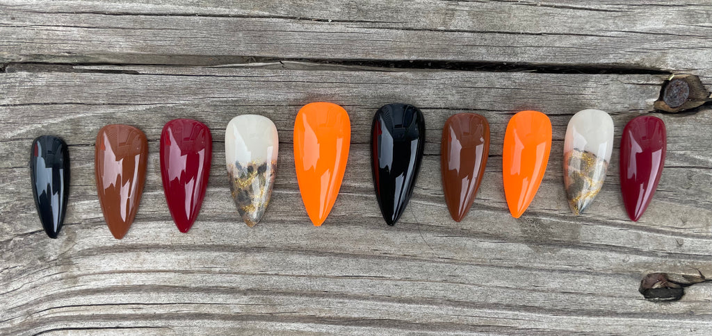 Harvest Skittles handmade fall skittle press on nails in burgundy orange brown and black with gold foil and leopard accent, stiletto