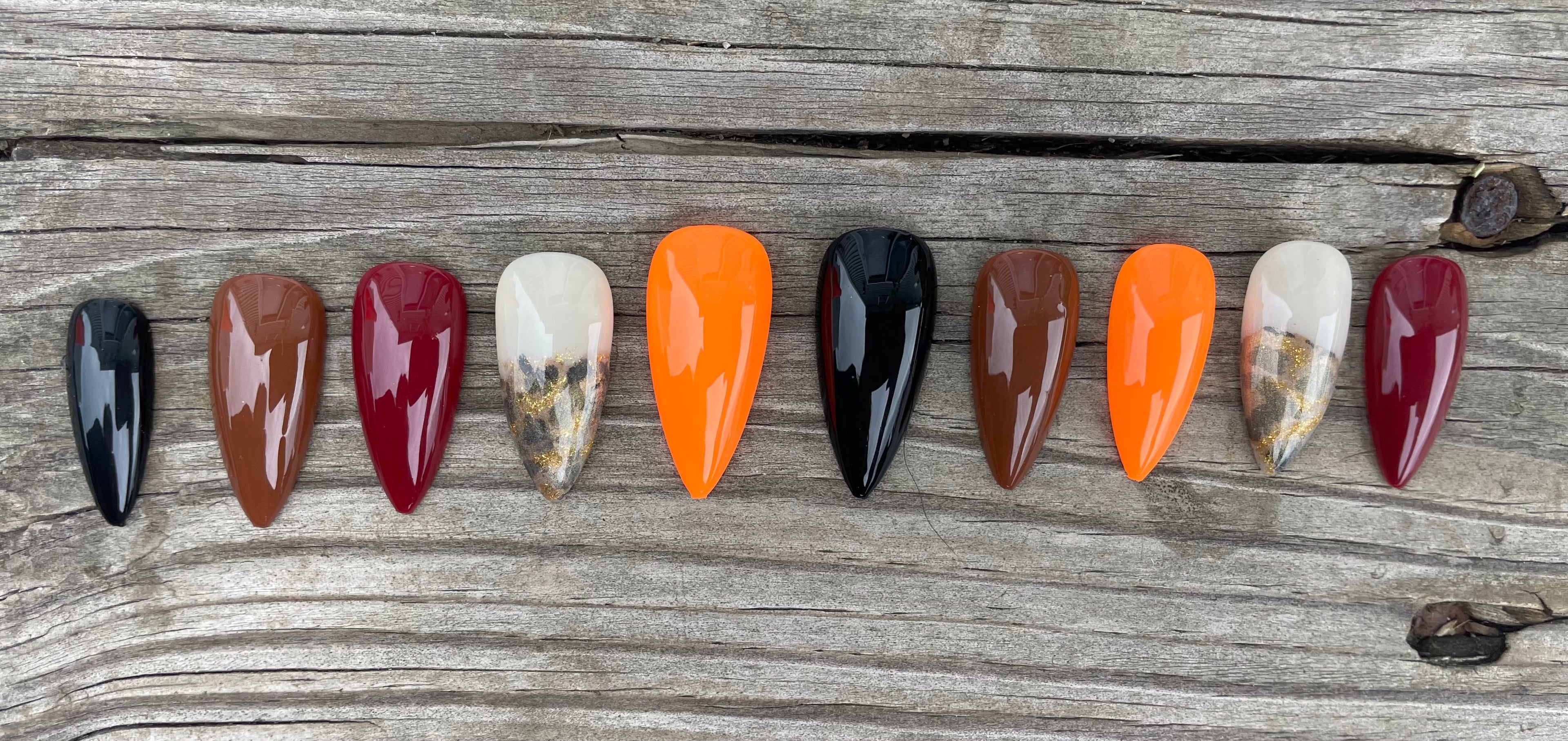 Harvest Skittles handmade fall skittle press on nails in burgundy orange brown and black with gold foil and leopard accent, stiletto